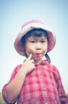 Cute Little Asian Girl Eating A Lollipop On Nature Background In Stock Photo