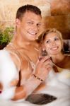 Young Couple Having Bath With Wine Stock Photo