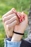 Hands Of A Couple Held Together Stock Photo