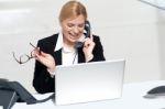 Woman Talking On Phone Holding Eye Glasses Stock Photo