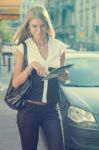 Young Business Woman With Tablet Computer Walking On Urban Stree Stock Photo