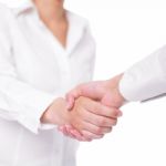 Handshaking Female Hands On White Stock Photo