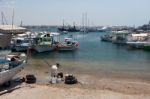 Old Man Preparing To Fish From The Beach At Paphos Cyprus Stock Photo