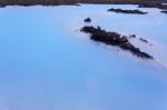 Milky White And Blue Water Between The Lava Stones Covered With Moss Stock Photo