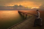 Man Waiting For Plane Fligh On Pier Stock Photo