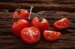 Organic Fresh Cherry Tomatoes On Wooden Background Stock Photo