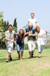 Happy Family Playing In The Park Stock Photo