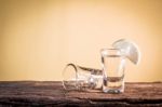 Glass Of Vodka On The Old Wooden Table Stock Photo