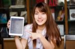 Portrait Of Thai Adult Student University Uniform Beautiful Girl Using Her Tablet Stock Photo