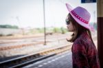 Girl Tourist Sitting On A Bench In A Train Station Stock Photo