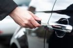 Man Inserting Car Key Into The Door Lock Stock Photo