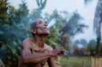 Old Man Smokes Cigarettes Stock Photo