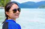 Face Of A Woman Is Smiling At The Camera On The Sea Background Stock Photo