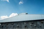 Thai Zinc Barn Against Blue Sky Stock Photo