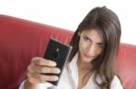 Confident Woman Taking Selfie On Sofa Stock Photo