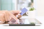 Closeup Hand Using Tablet And Credit Card Shopping Online Stock Photo