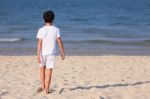 Boy Walking On Beach Stock Photo