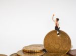 Miniature Businessman Stand On Euro Coins And Book Bank. Busines Stock Photo