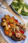 Oven Baked Meat With Potatoes, And Watercress Salad Stock Photo