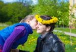 Daughter Kisses Mom In The Park Stock Photo