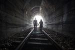 Couple Walking Together Through A Railway Tunnel Stock Photo