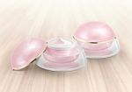 Pink Dome Cosmetic Jar On Wood Background Stock Photo