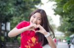 Portrait Of Thai Teen Beautiful Girl In Chinese Dress, Relax And Smile Stock Photo