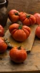 Freshly Picked Tomatoes, Place On Wooden Chopping Board And Table Stock Photo