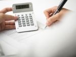 Bookkeeping With Calculator Stock Photo