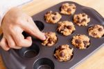 Woman Preparing Baking Chocolate Chip Muffin Stock Photo