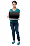 Salesgirl Presenting Brand New Laptop For Sale Stock Photo