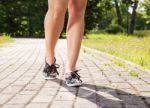 Female Feet On The Pavement Front View Stock Photo