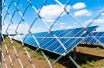 Solar Panels Behind Fence Stock Photo