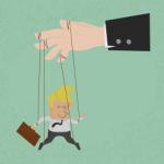 Businessman Marionette On Ropes Controlled Stock Photo