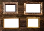 Old Gold Picture Frames On Wooden Wall Stock Photo