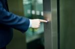 Hand Pressing Elevator Button Stock Photo