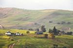 Alpine Village In Mountains. Smoke And Haze Over Hills Stock Photo