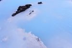 Milky White And Blue Water Between The Lava Stones Covered With Moss Stock Photo