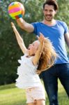 Happy Young Family, Father And Son Playing Ball In The Park Stock Photo