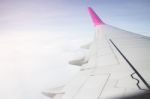 Airplane Wing Flying Above The Clouds Sunset Stock Photo