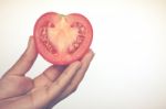 Half Cut Of Red Potato In Human Hand Stock Photo