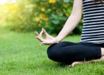 Woman Meditating in Park Stock Photo