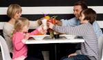 Family Toasting Smoothies In Restaurant Stock Photo