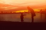 Mother And Daughter On Sunset Watching On Sky Stock Photo