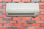 Wall Air Conditioning Hanging On A Brick Wall Stock Photo