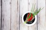 Red Hot Chilli Pepper And Scallions On Plate Stock Photo