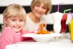 Cute Kid Enjoying Pasta And Juice Stock Photo