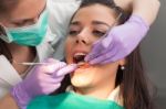 Dentist Examining A Patient's Teeth In The Dentist Stock Photo