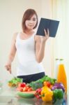 Young Woman Reads Cookbook Stock Photo