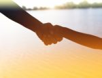 Two Hands Holding Puzzle Mother And Child Stock Photo